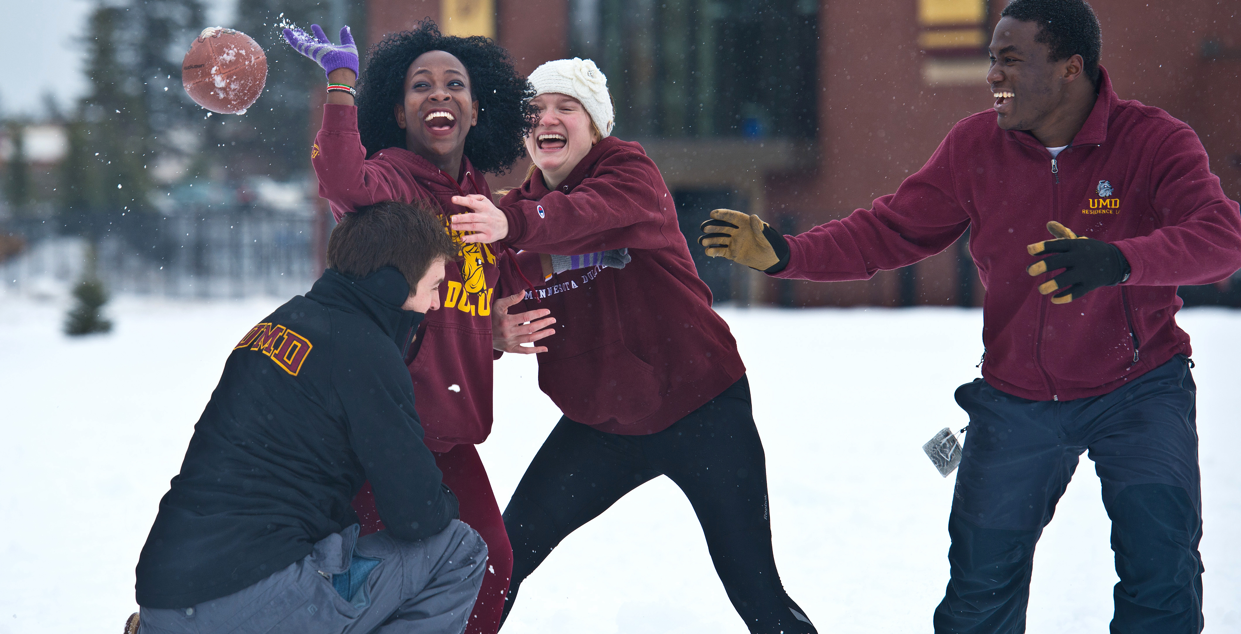 students playing in the snow